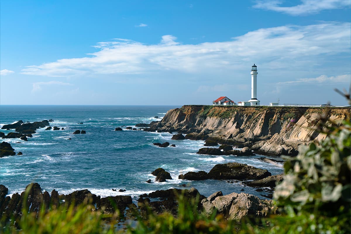 Point Arena lighthouse standing tall against a dramatic sky